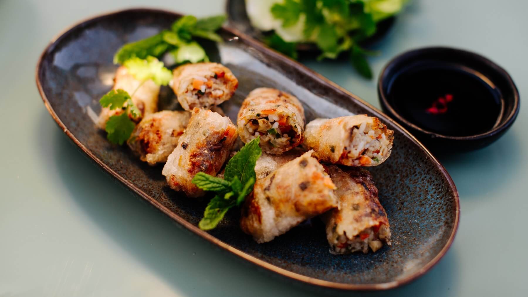 Vietnamesische Frühlingsrollen: Nem Ran sind die berühmten vietnamesischen Frühlingsrollen aus Hanoi – goldbraun frittiert, gefüllt mit Schweinefleisch, Karotten, Pilzen und mehr. 🌿 Serviert werden sie mit einem Fischsaucen-Dip, frischem Salat...