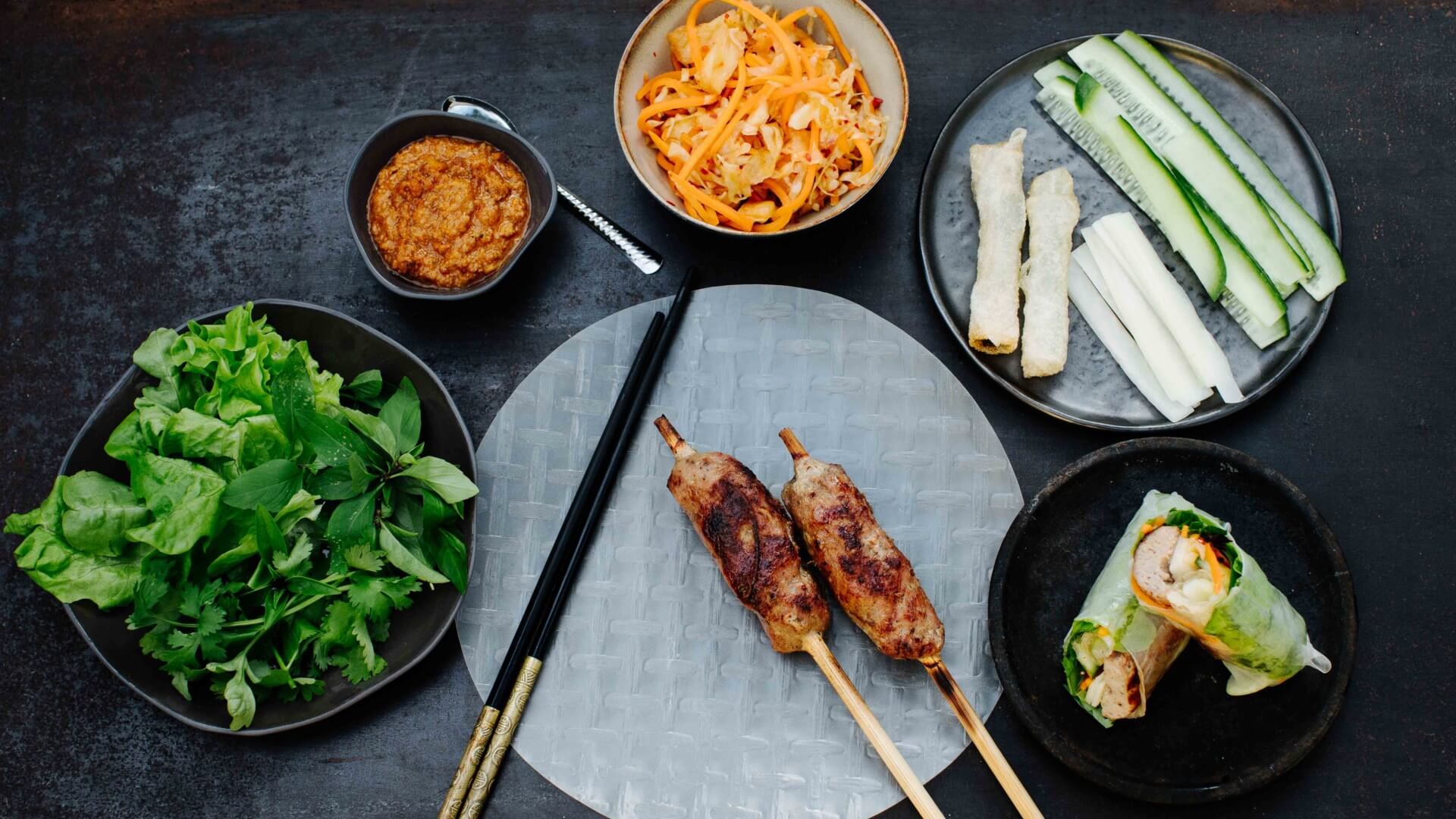 Gegrillte Fleischröllchen im Reispapier - Nem Nuong: Nem Nuong sind gegrillte Schweinefleischröllchen, die mit frischen Kräutern und Salat in Reispapier gewickelt und in eine süß-scharfe Erdnusssauce (Nuoc Leo) getunkt werden. 🥢 Dieses Rezept...